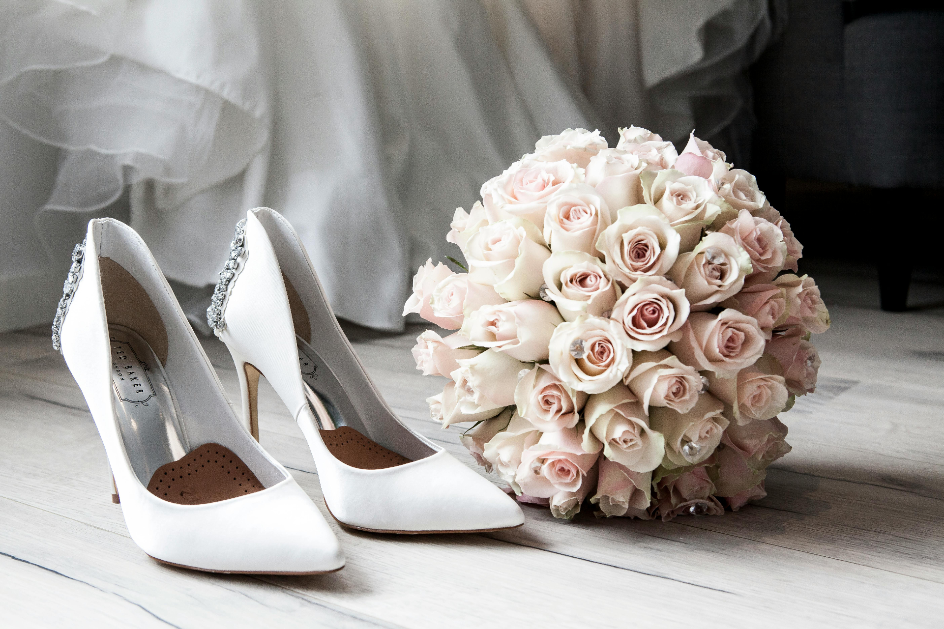 Wedding shoes and bouquet in soft pink tones